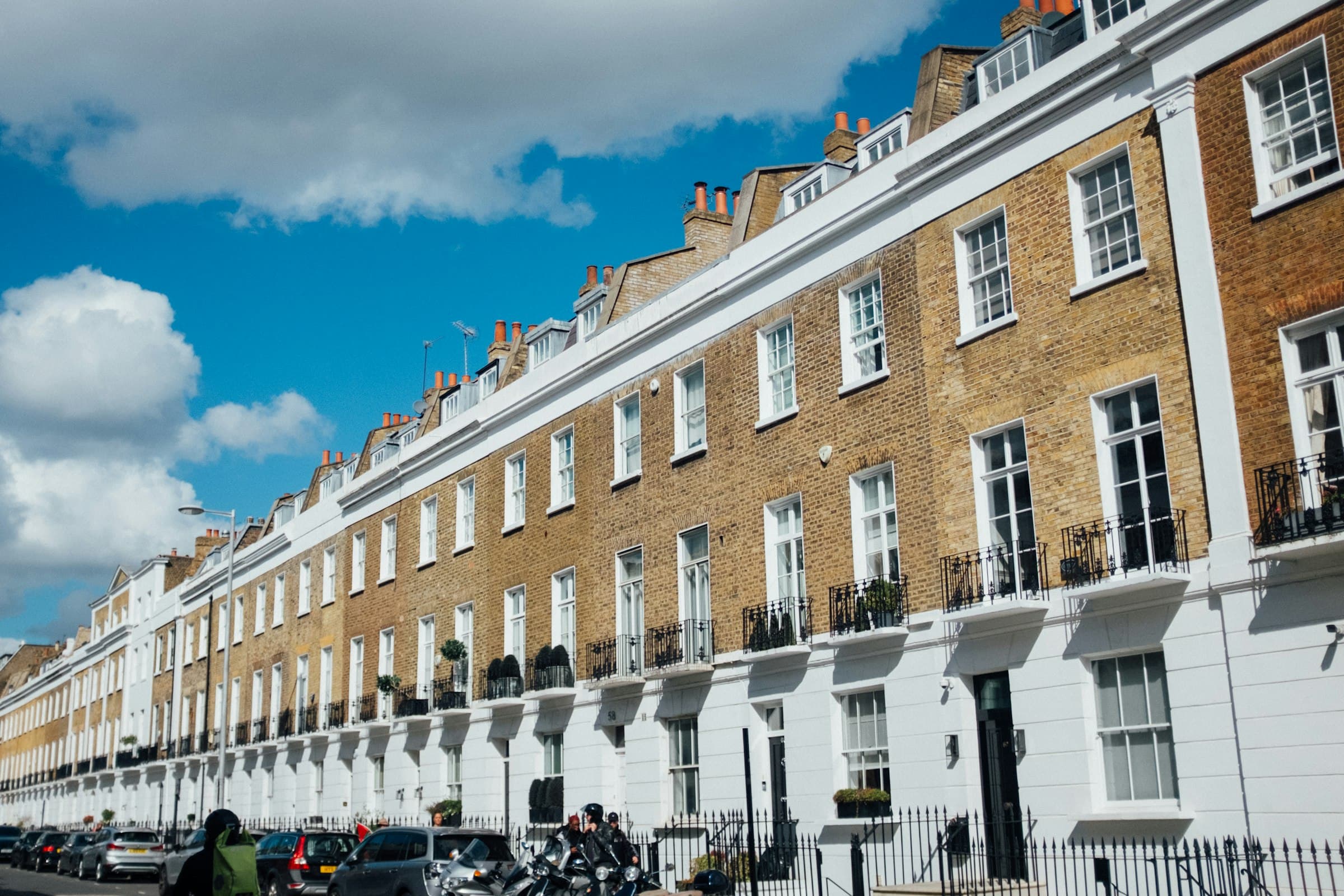 A row of traditional terraced houses on a residential street in England